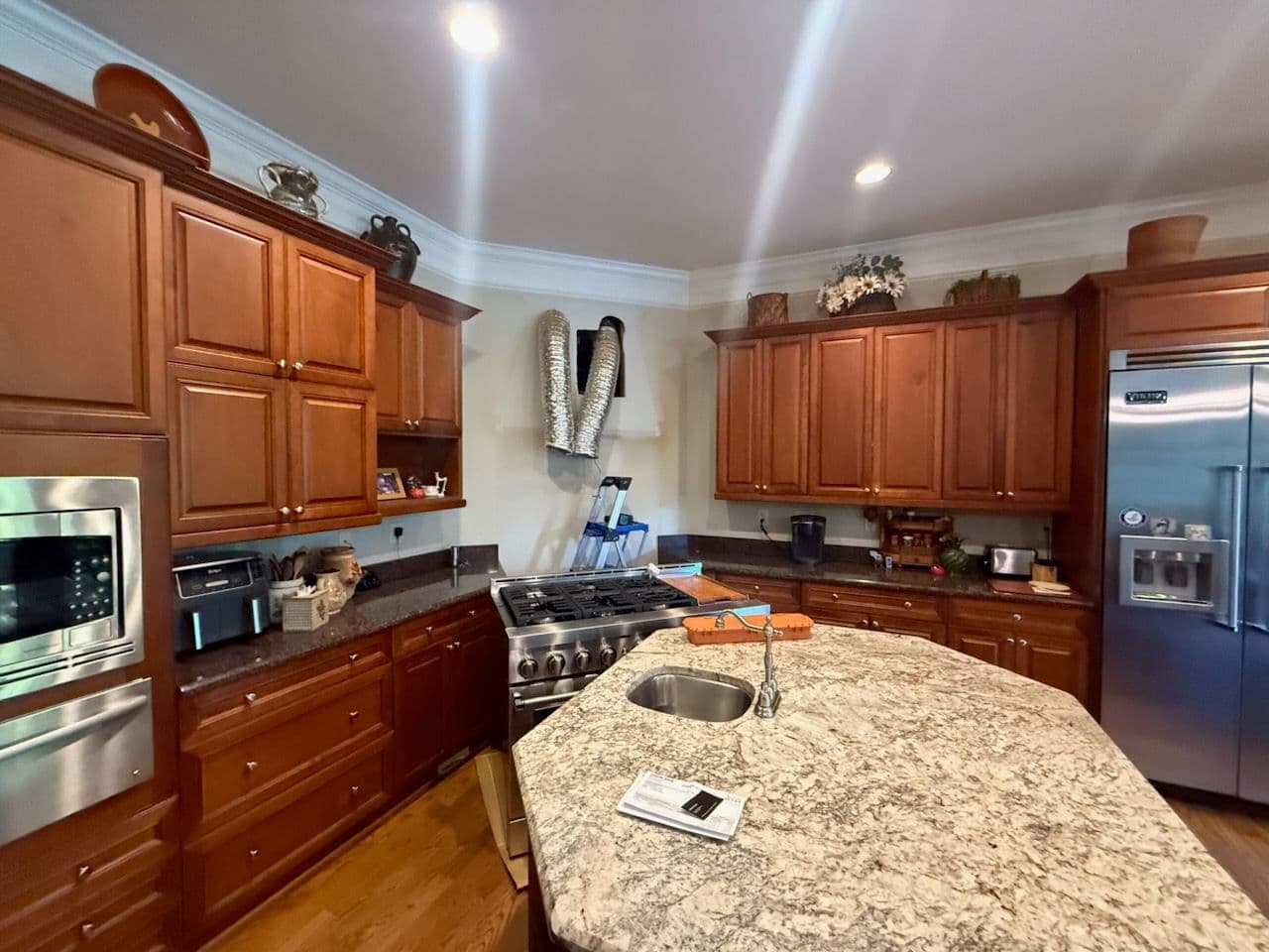 Custom Kitchen Remodel Featuring Rich Wooden Cabinetry and Granite Countertops