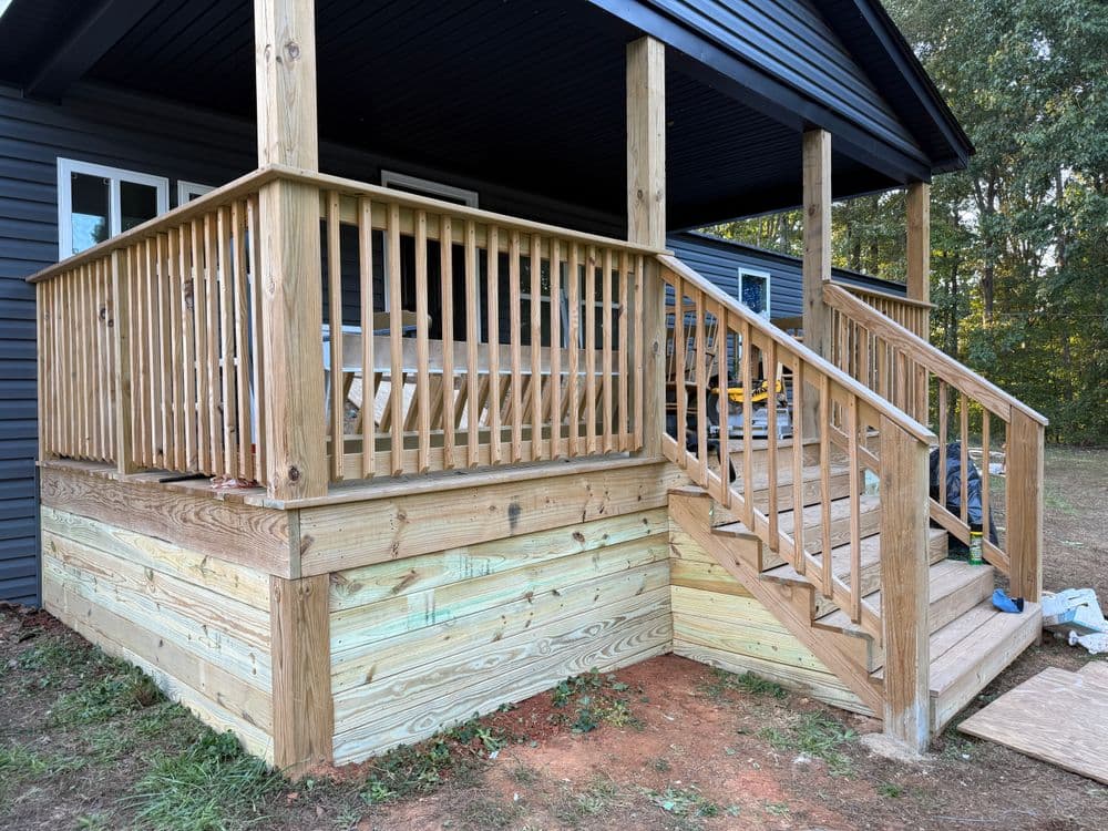 Wooden deck with railings and stairs, featuring natural finish and modern design.