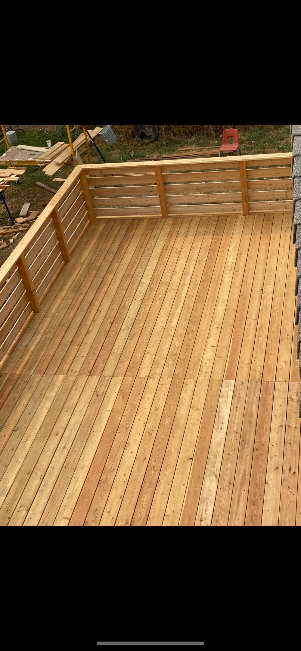 Newly completed wooden deck showcasing smooth, polished planks and sturdy railings.