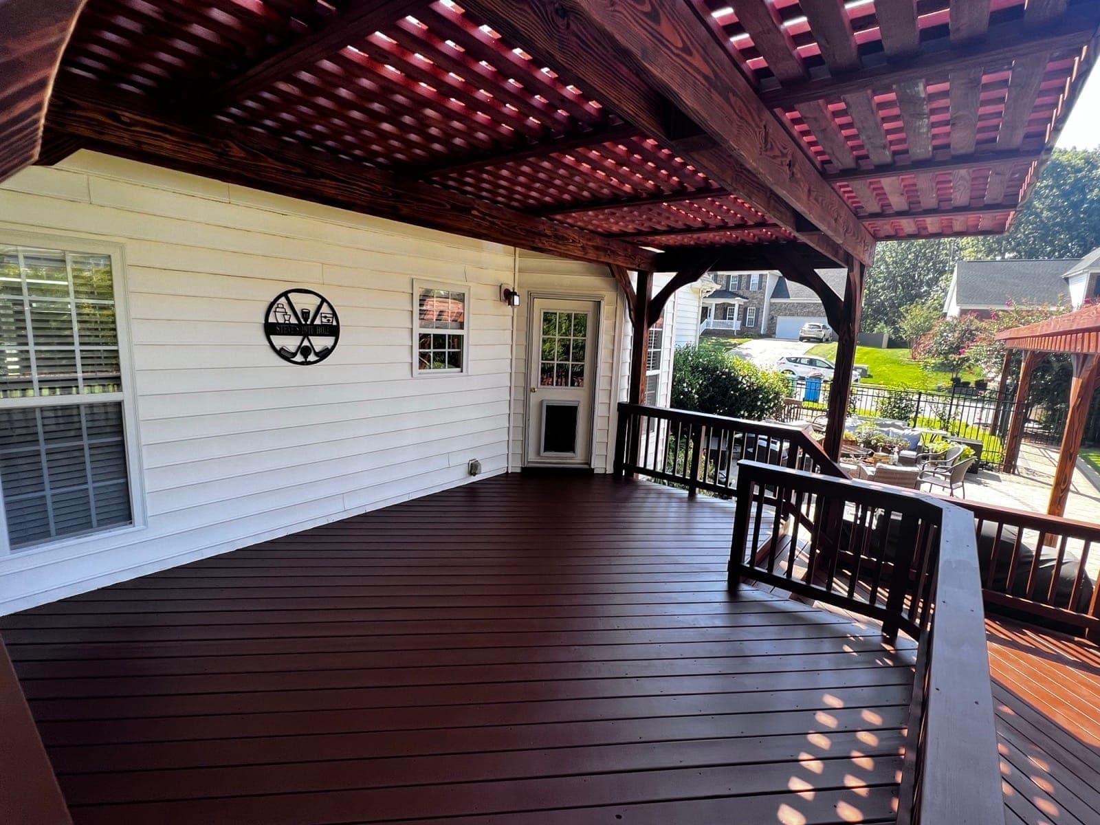 Cedar pergola over a mahogany-stained deck attached to a Carolinas home