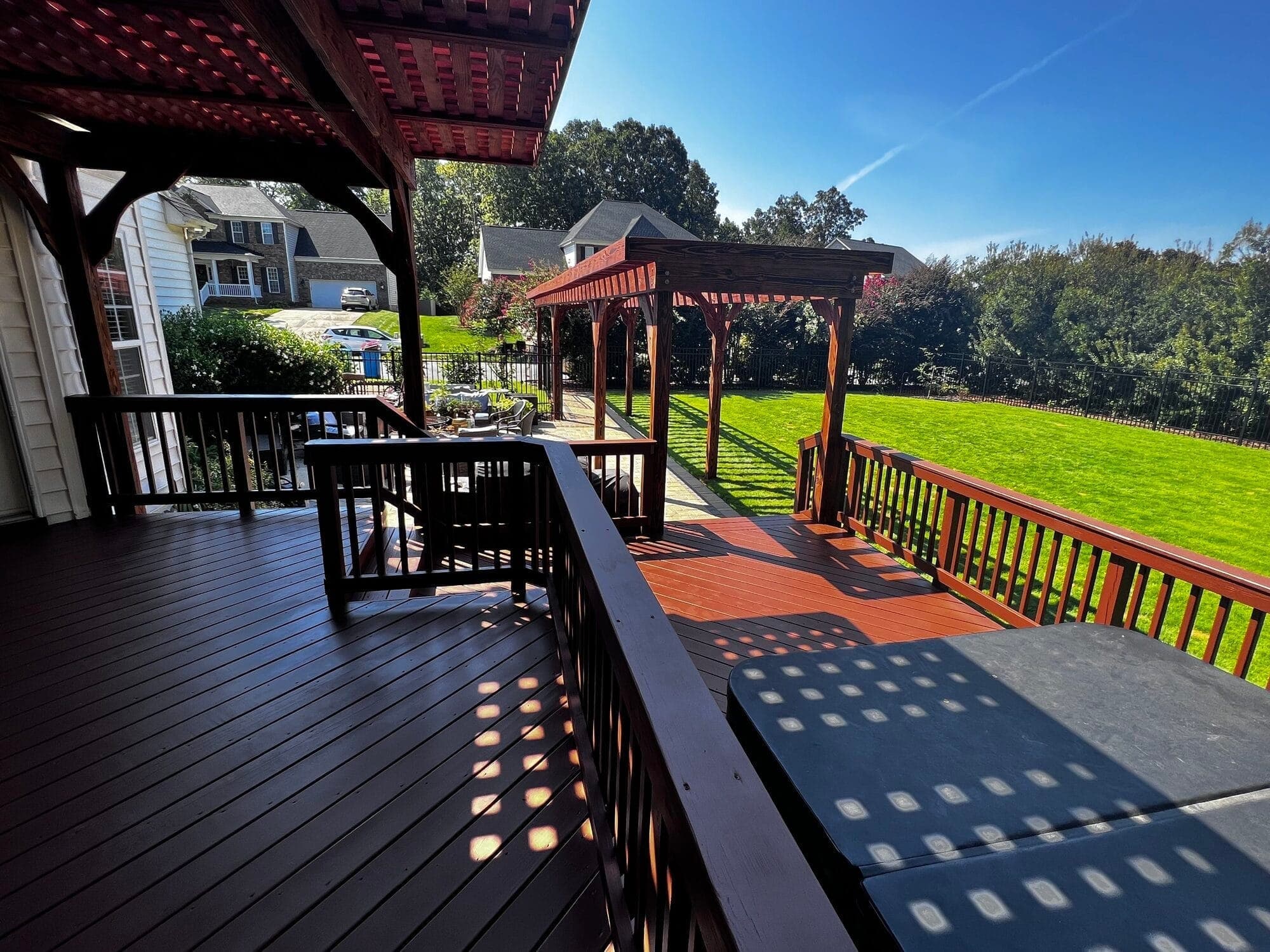 Covered deck with string lights at dusk, built by Berg Custom Builds