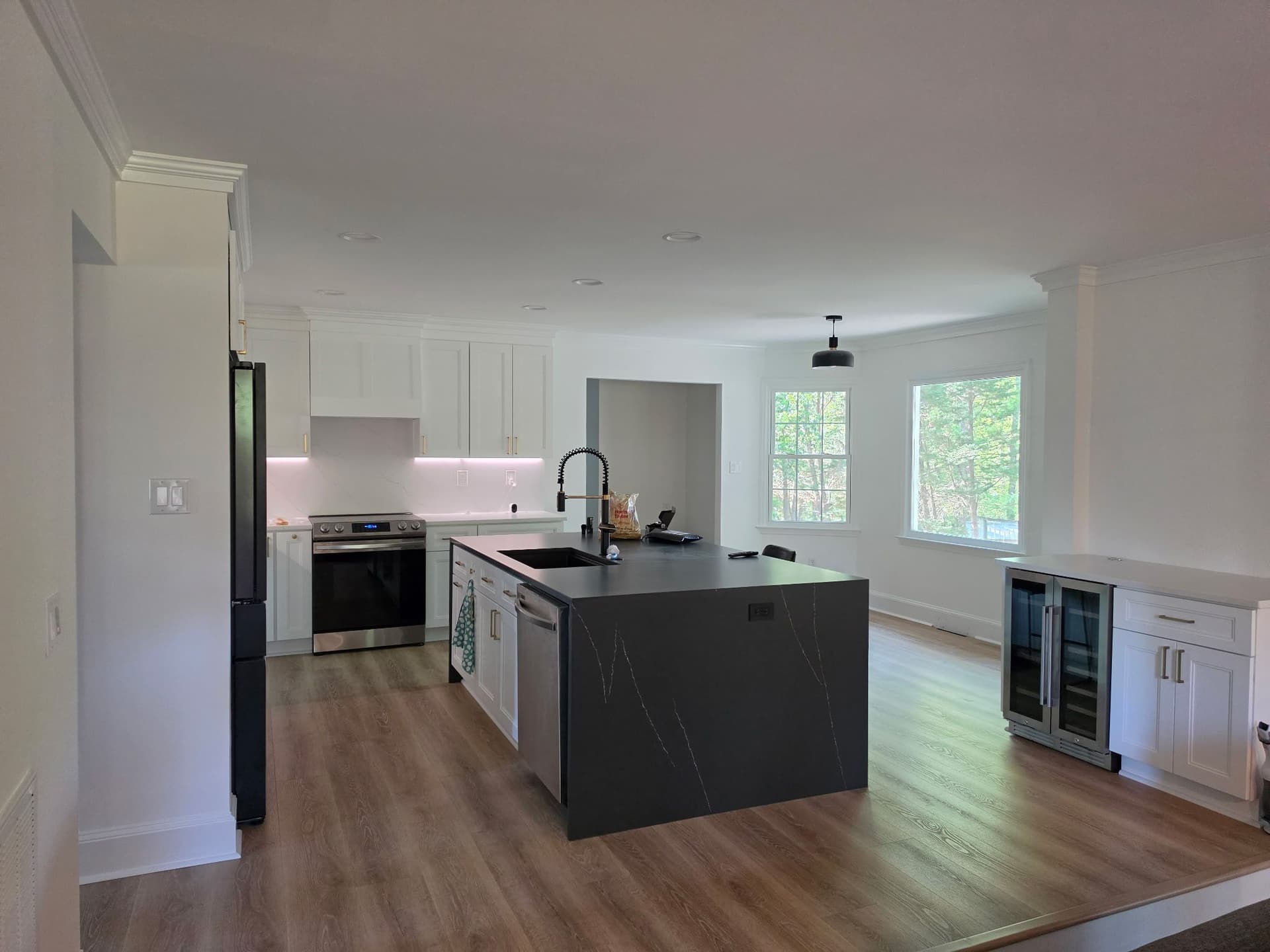 Modern Kitchen Remodel with Dark Island and Wine Cooler image